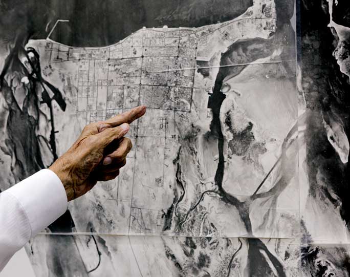 Architect and urban planner Dr. Abdulrahman Makhlouf points to an aerial photograph of Abu Dhabi dating from 1973. Within five years of working in Abu Dhabi, the modern grid he was hired to set in place was already evident. Photograph by Ziyah Gafic.