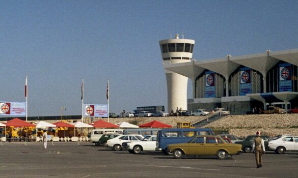 The Dubai International Airport was the location for the British Building and Construction Equipment Exhibition, 1974. Union Jack flags were hung on the terminal's glass facade. Large-scale equipment was on display and for sale in the parking lot. Courtesy of John R. Harris Library.