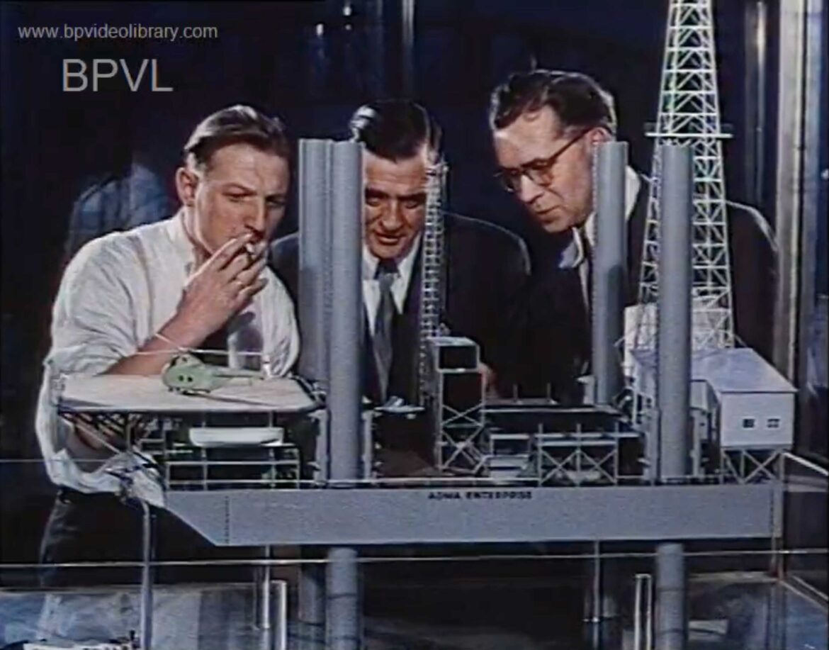 These men, who might be the "American designers" referred to in the film, admire the craftsmanship of a dynamic model of the oil platform, ADMA Enterpise. ADMA for Short (1958).